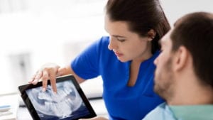 Dentist going over dental x-rays with patient